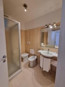 a bathroom with two sinks and a toilet and a shower at Hotel Virgilio in Orvieto