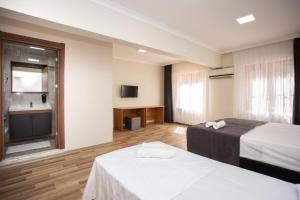 A bed or beds in a room at Türkler Suite Hotel