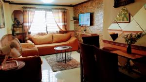 a living room with a couch and a table at Greenhills Garden Square 2BR & 2 Toilets in Manila
