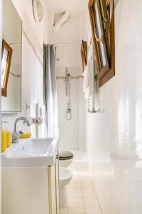 a white bathroom with a toilet and a sink at Appartamento Sant'Ambrogio in Florence