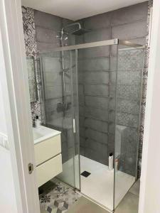 a bathroom with a glass shower and a sink at J. Casa con vistas en Lira - Carnota in Lira