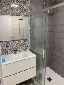 a bathroom with a sink and a glass shower at J. Casa con vistas en Lira - Carnota in Lira +48 photos