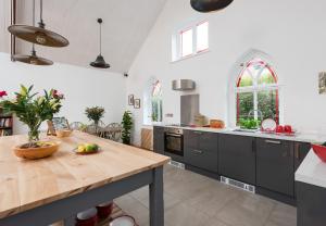 a kitchen with a wooden counter top in a room at CHESTER'S ONLY TIN CHAPEL - UNIQUE, SPACIOUS 2 BEDROOMS, GARDEN AND FREE PARKING in Chester
