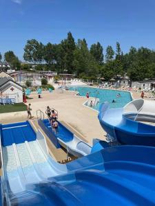 a water park with a slide and a beach at Grand mobil home exposé sud, 2 salles de bain in Onzain