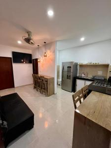 a kitchen and living room with a table and a counter at zara's apartamento en coveñas in Coveñas
