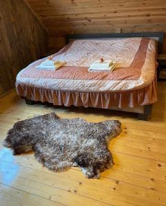 a dog laying on the floor next to a bed at Domek u Janiego in Milówka +22 photos