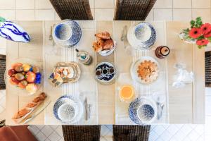 a table with cups and plates of food on it at Riad Landais in Bénesse-Maremne