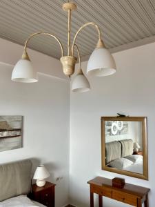 a bedroom with a ceiling fan and a mirror at Balcony of Koroni in Koroni