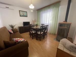 a living room with a couch and a table with chairs at Apartment Benky Pican in Pićan
