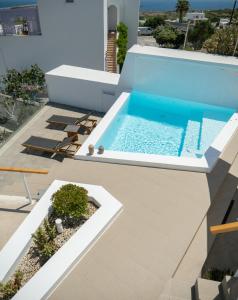 a swimming pool on the roof of a house at Valery Suites in Fira