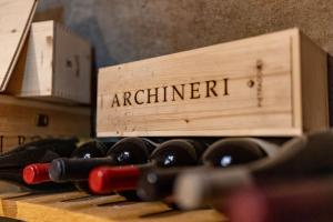 a wooden box filled with wine bottles on a table at Donna Carmela Resort & Lodges in Riposto