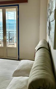 a bedroom with a bed with a view of the ocean at Balcony of Koroni in Koroni