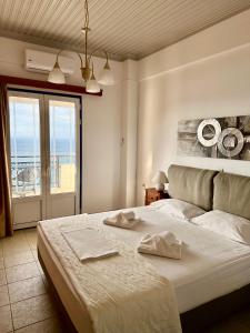a bedroom with a large bed with a view of the ocean at Balcony of Koroni in Koroni