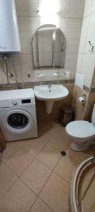 a bathroom with a sink and a washing machine at Central Plaza - Studio - Sunny Beach in Sunny Beach