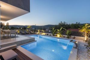 a swimming pool on the roof of a house at Villa ToDo with heated pool and jacuzzi in Vinišće