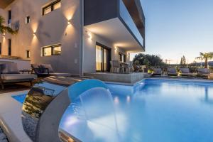 a swimming pool in the backyard of a house at Villa ToDo with heated pool and jacuzzi in Vinišće