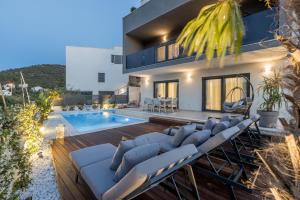 a villa with a swimming pool and a house at Villa ToDo with heated pool and jacuzzi in Vinišće