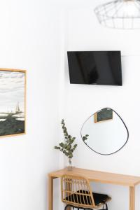 a living room with a mirror and a chair at Annis House in Skiathos Town