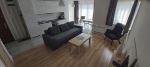 a living room with a couch and a table at HomeBaltic in Łeba