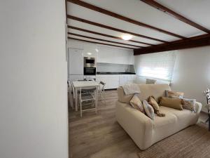 a living room with a couch and a dining room at Tu Piso en Portonovo in Portonovo
