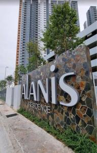 a sign for anant exchange in front of some buildings at Qilayna guest room in Sepang