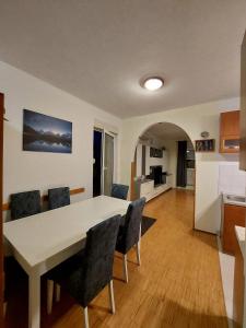 a kitchen and dining room with a table and chairs at Apartment Adriatic, Cres in Cres