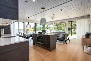 a kitchen and living room with a table and chairs at Kasnäs Marina Seafront in Kasnäs