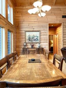 a dining room with a wooden table and chairs at Grand View Home with 360 Degree Mountain View in Tellico Plains