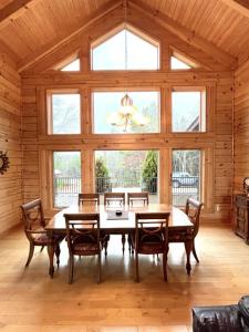 a dining room with a table and chairs and a large window at Grand View Home with 360 Degree Mountain View in Tellico Plains