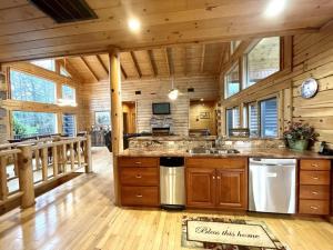 a kitchen with a large island in a log cabin at Grand View Home with 360 Degree Mountain View in Tellico Plains