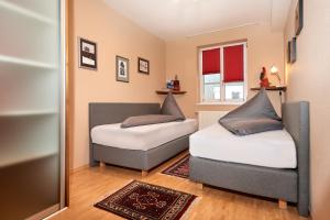 a bedroom with two beds and a mirror at Papagenoblick in Filzmoos