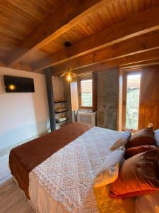a bedroom with a large bed in a cabin at Emily's House in Castro Daire