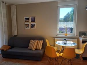 a living room with a couch and a table at Apartament blisko plaży in Pobierowo