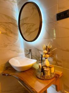 a bathroom with a sink and a mirror on a table at Emily's House in Castro Daire