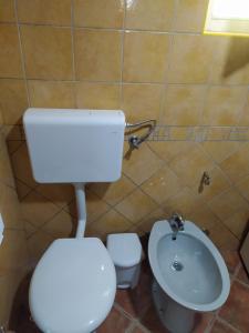a bathroom with a toilet and a sink at Lenilenii Bungalow in Jajce