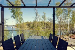 - Balcón con mesa y sillas y vistas al lago en Villa Eslahti - Seafront/Jacuzzi, en Porvoo