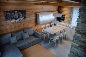 a living room with a couch and a table and a kitchen at ALPEART BOHINJ HOLIDAY units in Bohinj