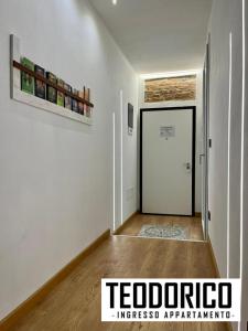 a hallway with a white room with a door at Teodorico Room & Apartment in Verona