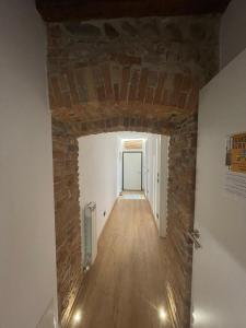a room with a brick wall and a hallway at Teodorico Room & Apartment in Verona