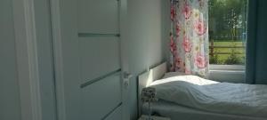 a small bedroom with a bed and a window at Mazurskie Wzgórze BIS z basenem in Rydzewo +106 photos