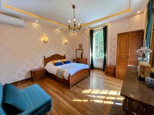ein Schlafzimmer mit einem Bett und einem Sofa in der Unterkunft Château de Moliens in Moliens