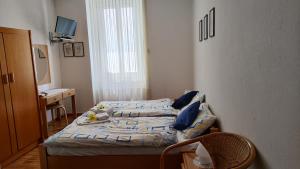 a small bedroom with two beds and a mirror at Hotel Scaletta in Locarno