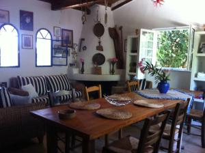 a dining room with a wooden table and chairs at Vounaki Seaside Dreamland! in Kyparissia