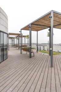 a wooden deck with benches on top of a building at Holysuite Savyon View Tower in Jerusalem