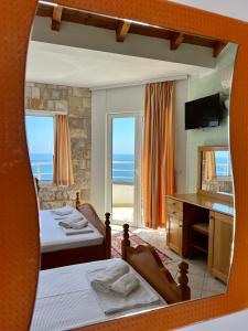 a view of a bedroom with two beds and a mirror at Apartments Amina in Ulcinj