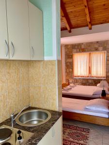 a kitchen with a sink and a bed in a room at Apartments Amina in Ulcinj