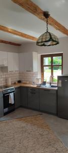 a kitchen with a sink and a stove top oven at Niedźwiedziówka in Mrągowo