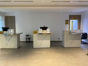 a room with white walls and tables with boxes on them at Roya Al Andalus Hotel in Al Madinah