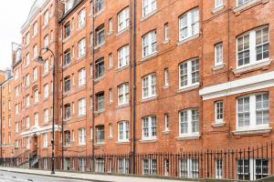 a large red brick building with white windows at Cozy Apt in Central London in London