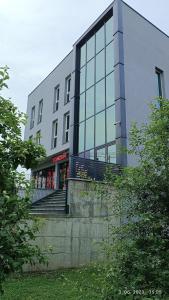 a building with people standing outside of it at Grand Apartman in Živinice